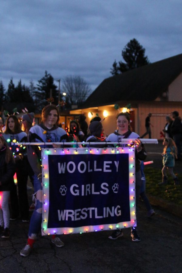 SWHS girls wrestling march along with the SWHS band and several other school organizations.