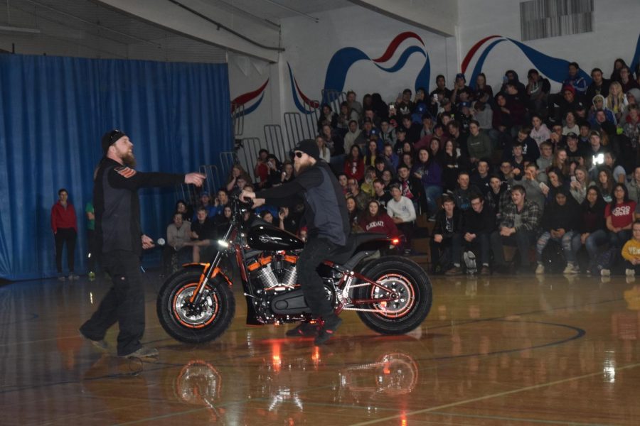 Harley Davidson workers rev across the SWHS gym to show off thier collaboration with high school students, in preparation for local project. 