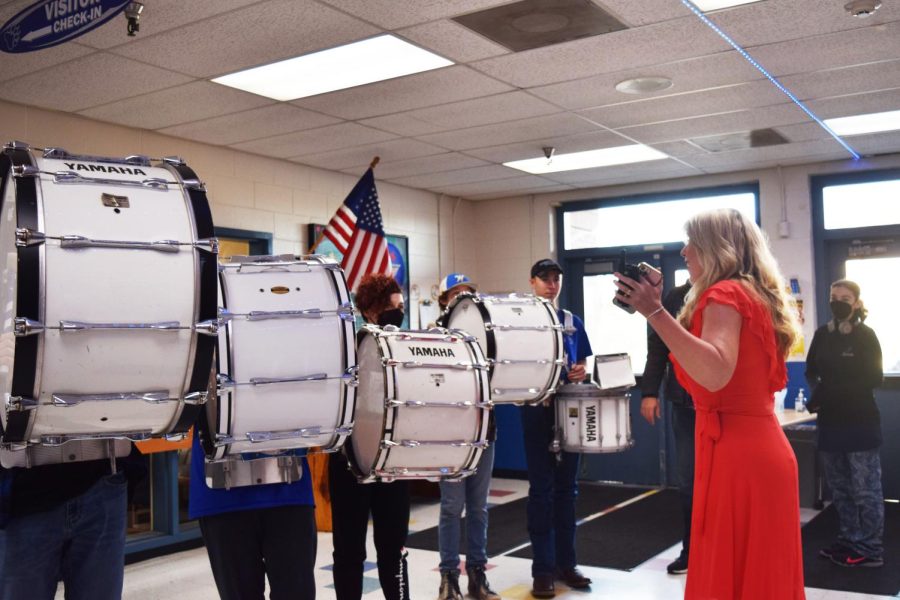 Principal Kerri Carlton helps the SWHS Drum line send off the Nursery and Landscape team on Thursday, March 24.  