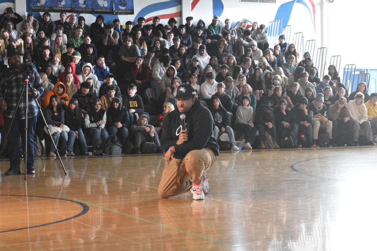 William Winfield kneels to talk to the students at the Martin Luther King Assembly  on January 16