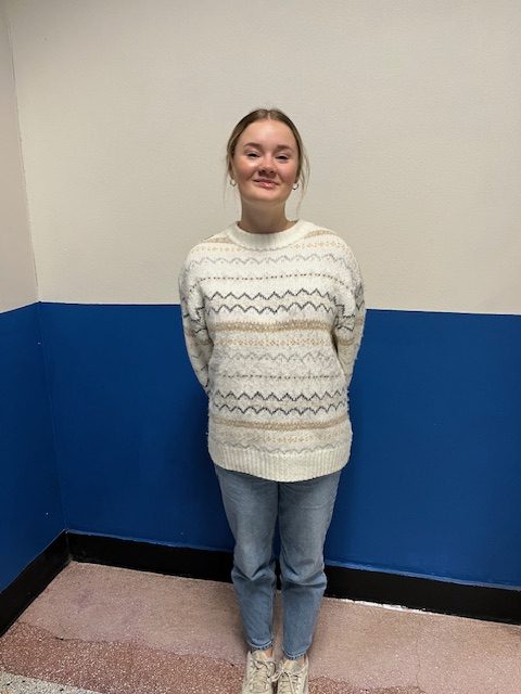 Bella Blankenship Miller proudly showing off her White Out day sweater