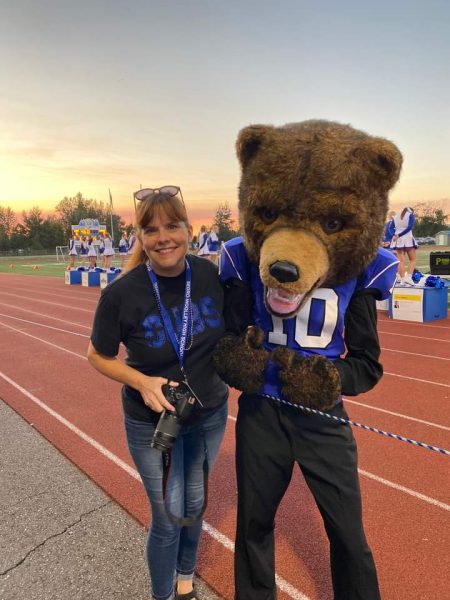 Clayton Hall the Victor E. Cub Mascot stands with SWHS teacher Kelly Hawkins at a fall game. 