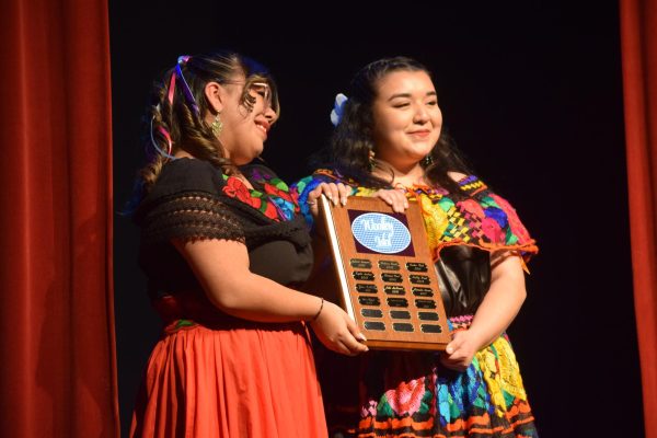 Meleny Lamas and Alexia Ceja hold first place plaque at Woolley Idol event on April 12. 