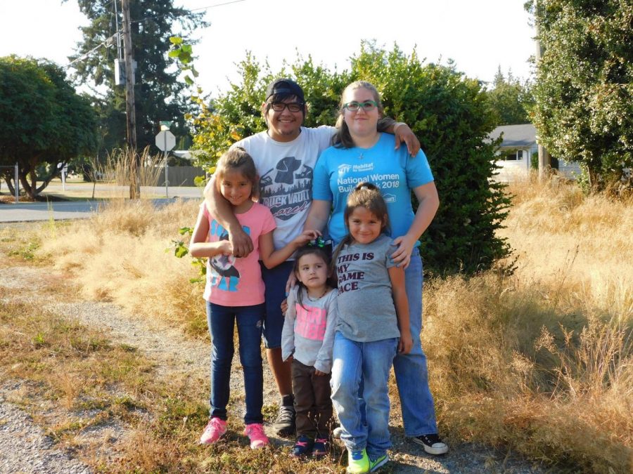 Local family stands at the site of their future home soon to be built by SWHS students. Courtesy of Habitat for Humanity