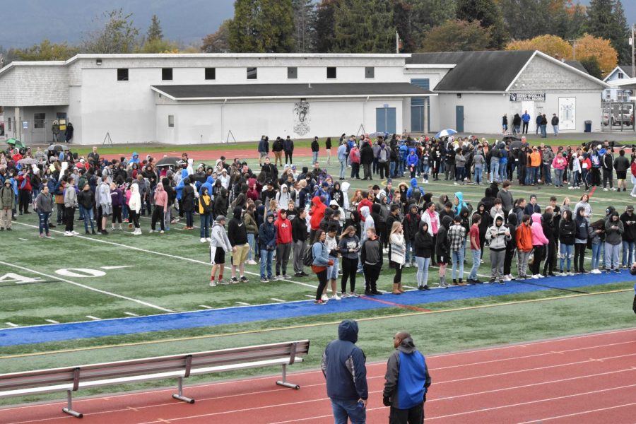 SWHS students gather on the field as they await further instruction. The statewide ShakeOut drill was deemed a success. Photo by Anna Ferdinand.