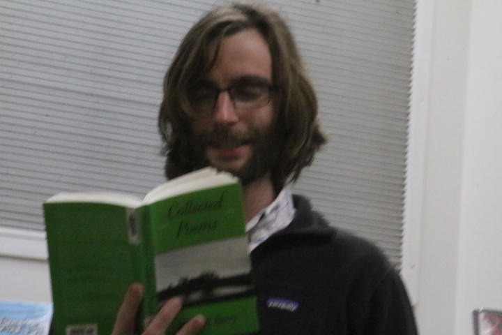 Brennen Vanloo reads a poem at poetry reading on Thursday the 13th