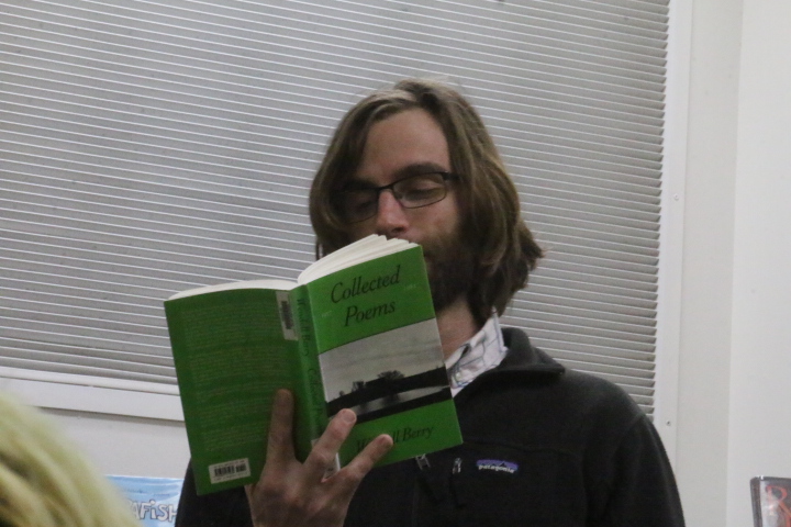 Brennen Vanloo reads a poem at poetry reading on Thursday the 13th