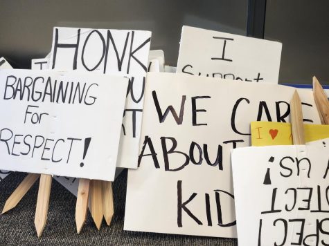 Students and Teachers put signs in a pile before going into the board meeting at Mount Vernon High School on May 23.