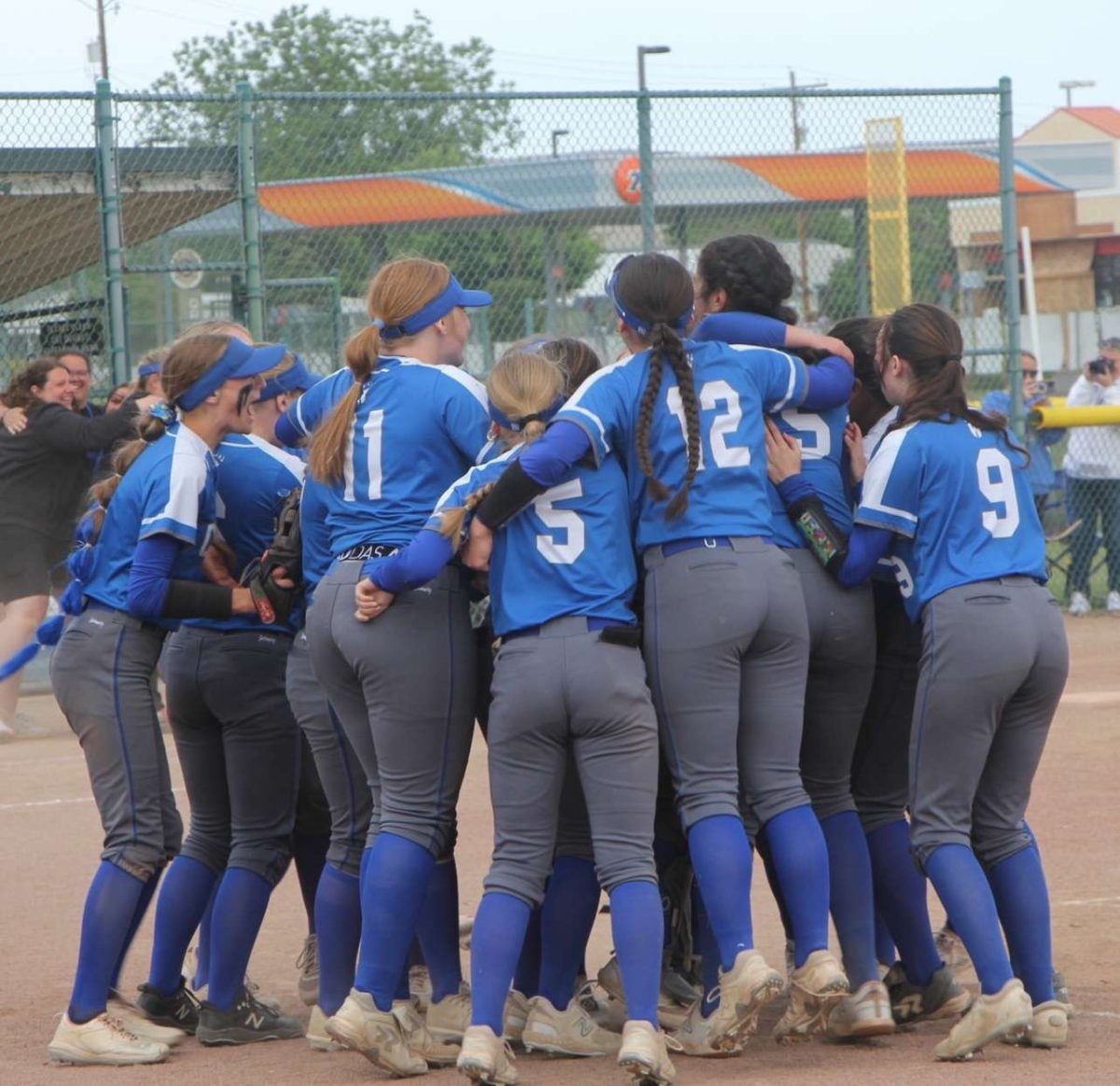 SWHS Fastpitch team gathers into an excited huddle after winning the state championship game against Tumwater. 