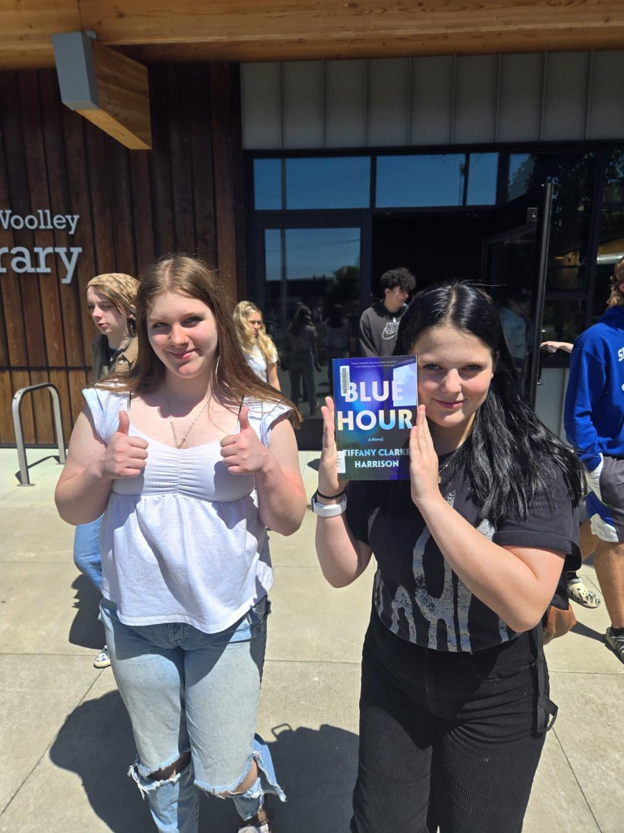 Caydie Larson and Peyton Raitz check out books after a field trip to the Central Skagit Library on June 3, 2025.  Six Classes of tenth grades visited the library during their class period.